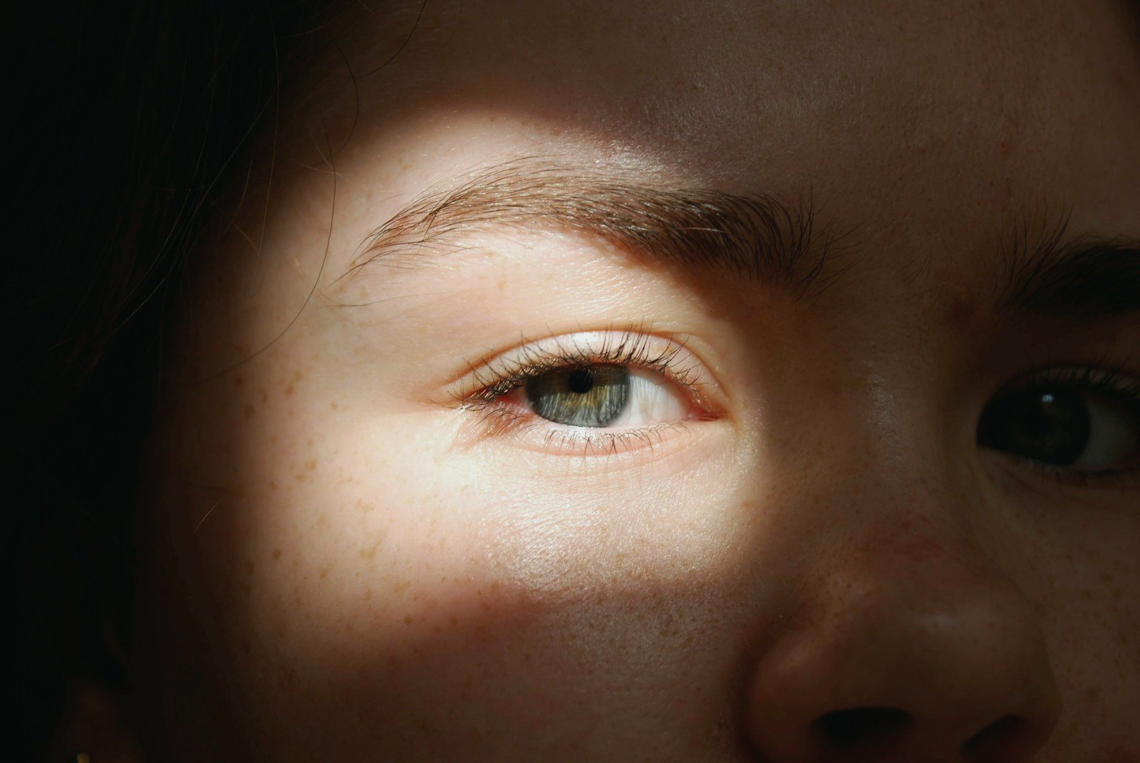 Close-up of a human eye in warm, soft light